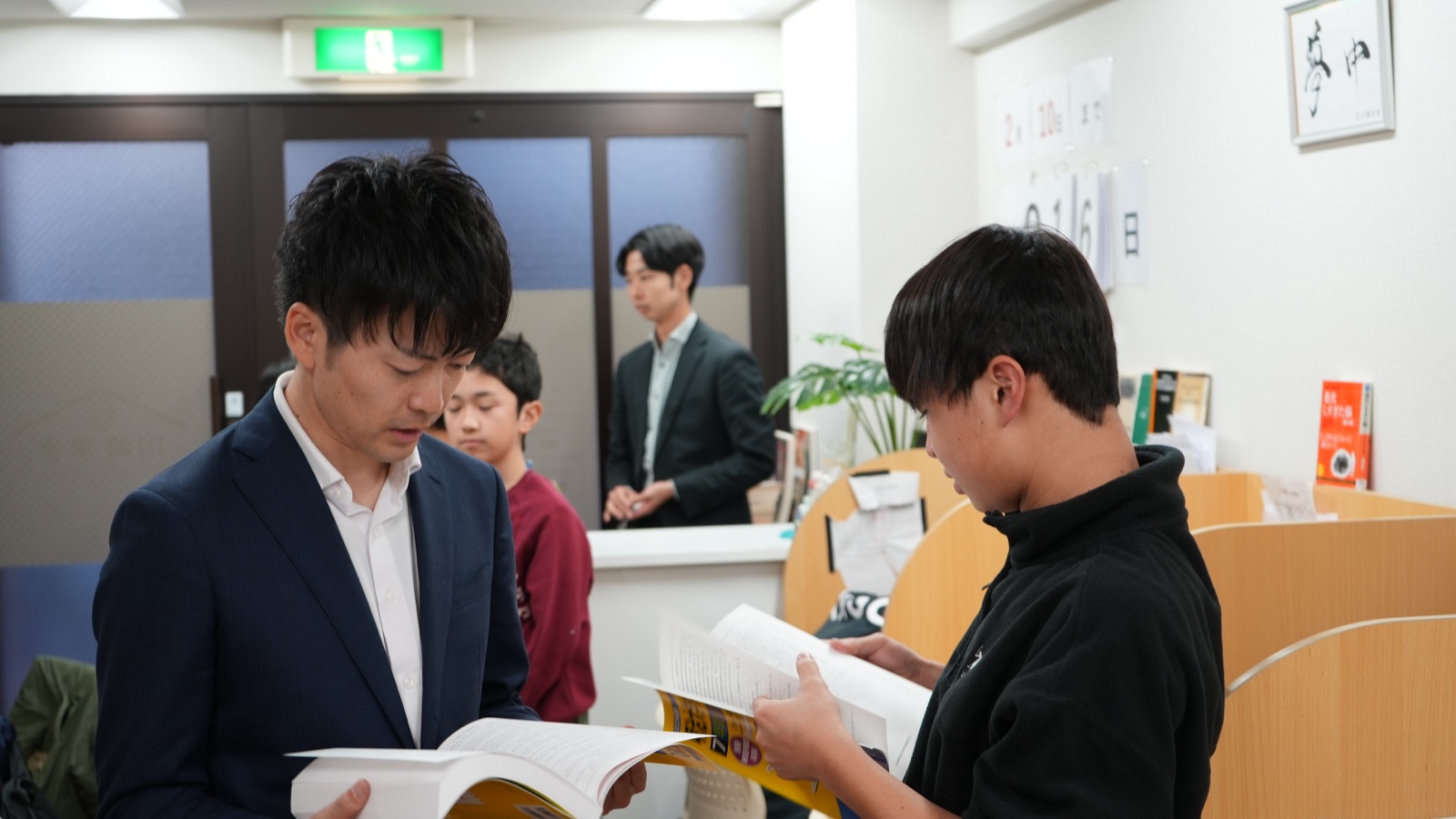 先生と生徒が題材を読む様子